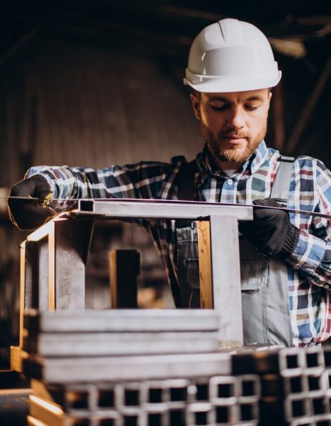 workman-wearing-har-hat-with-measuring-ruler-factory_1303-26639